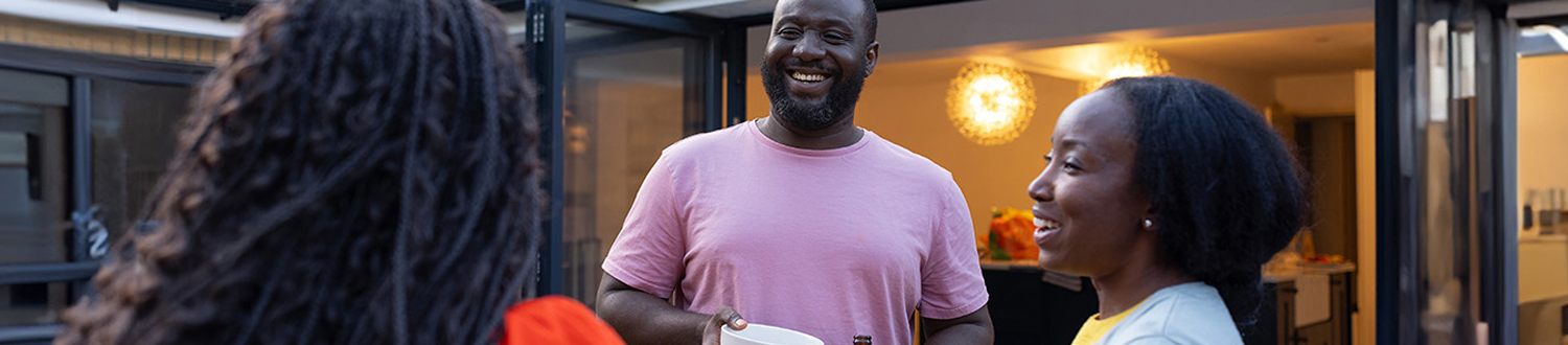 A person laughing with two others