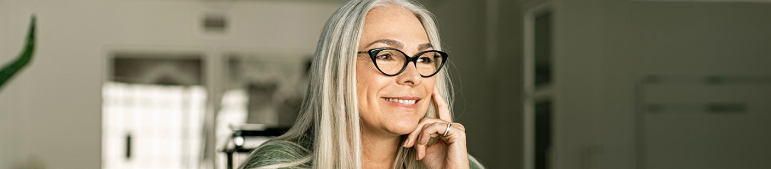 A person smiling with their hand to their face
