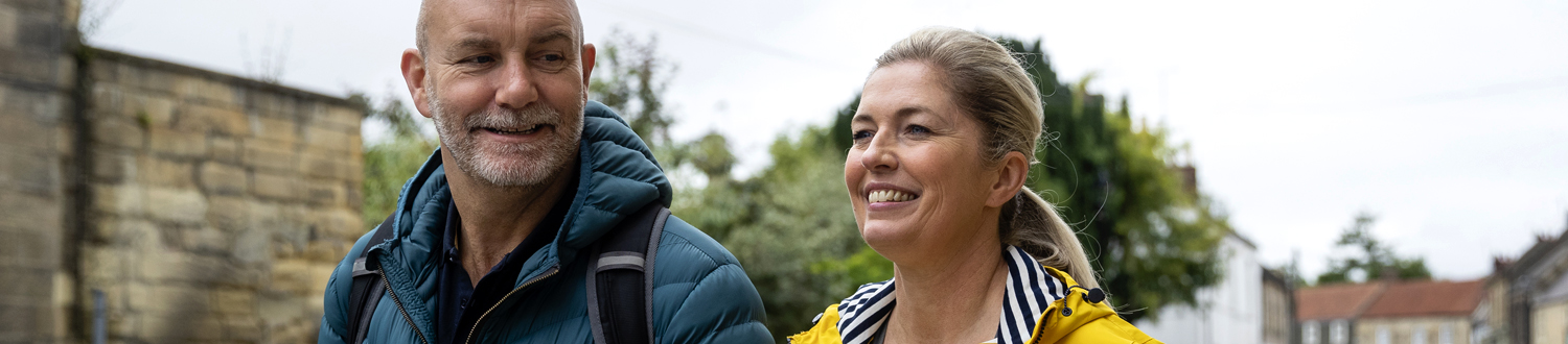 Two people smiling outside