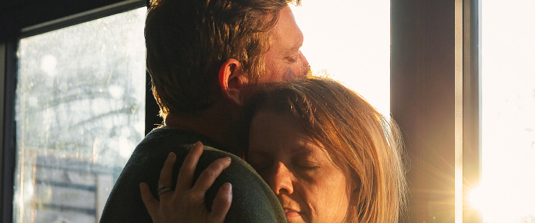 Two people hugging 