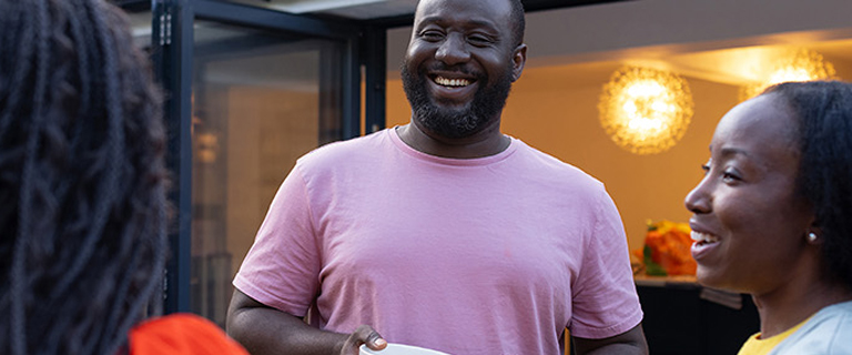 A person laughing with two others