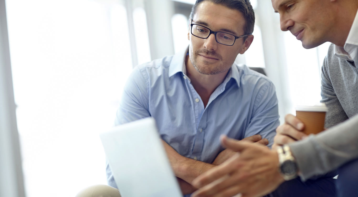 2 men looking at a piece of paper