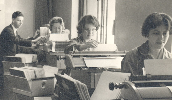 Black and white photo of three female typists