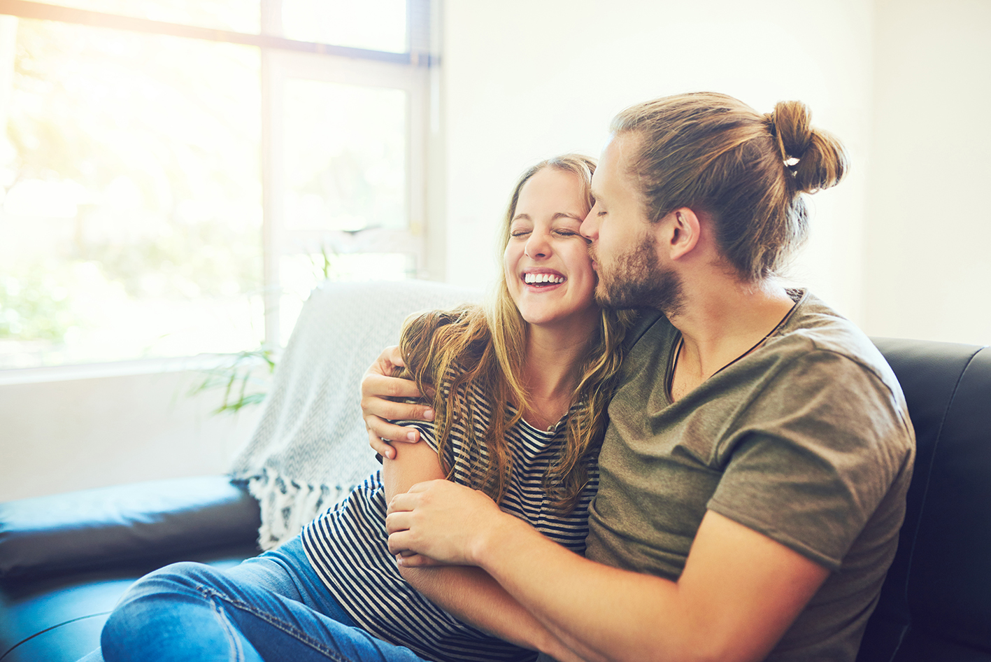 couple cuddled up on a sofa