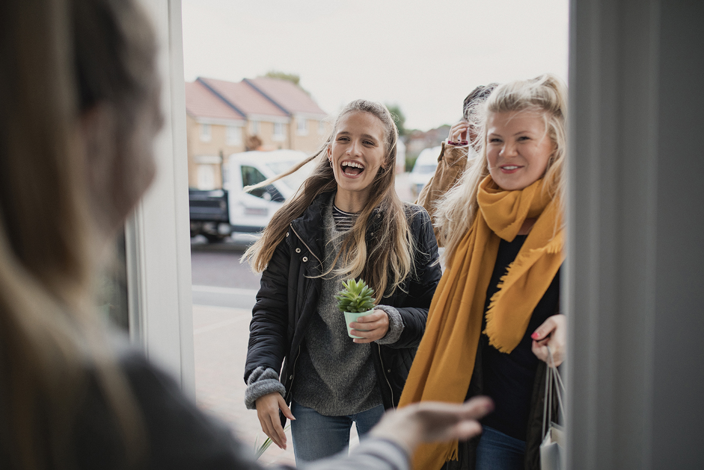 2 women in front of a front door