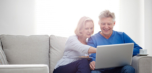 Woman and man both looking at a laptop screen
