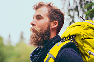 man with beard and yellow backpack