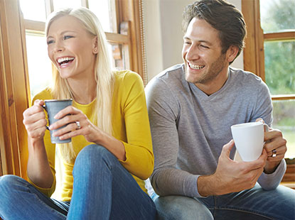 woman and man sitting on floor drinking tea