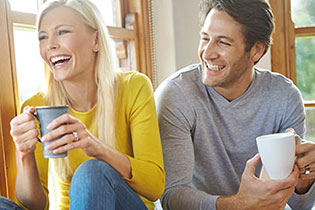 man and woman drinking tea and talking on floor