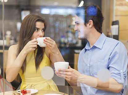 woman and man talking whilst drinking tea
