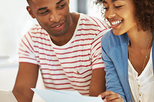 man and woman looking at piece of paper