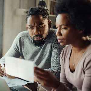 Two people sat looking at a piece of paper