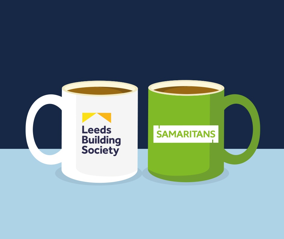white mug displaying the Leeds Building Society logo, green mug displaying Samaritans logo