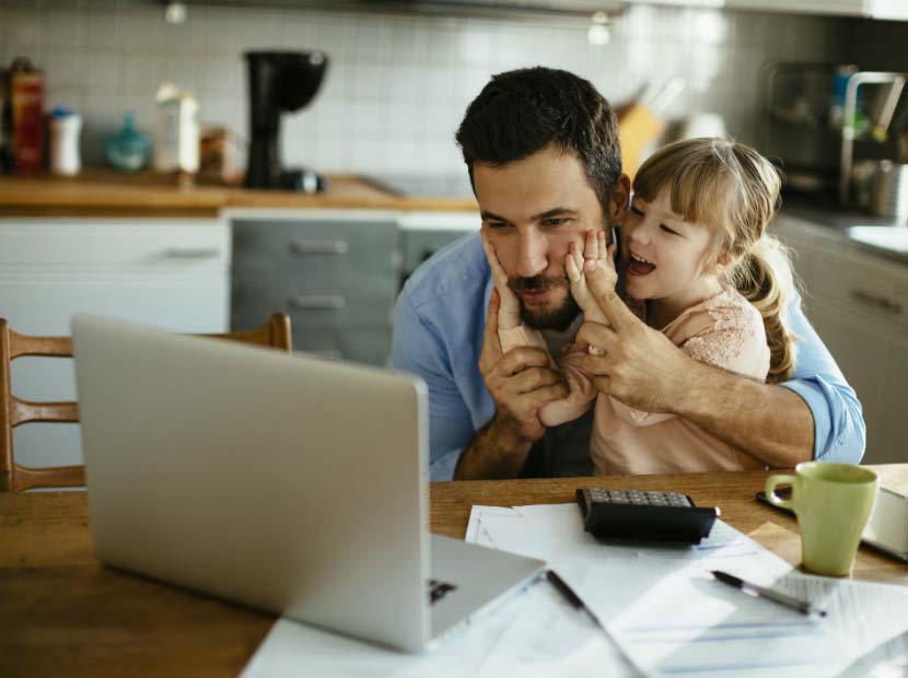 Little girl interupts Dad using laptop in kitchen