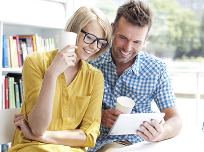 man and woman looking at tablet