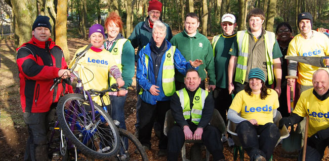 Members of Leeds Building Society in the woods with tools and bicycles