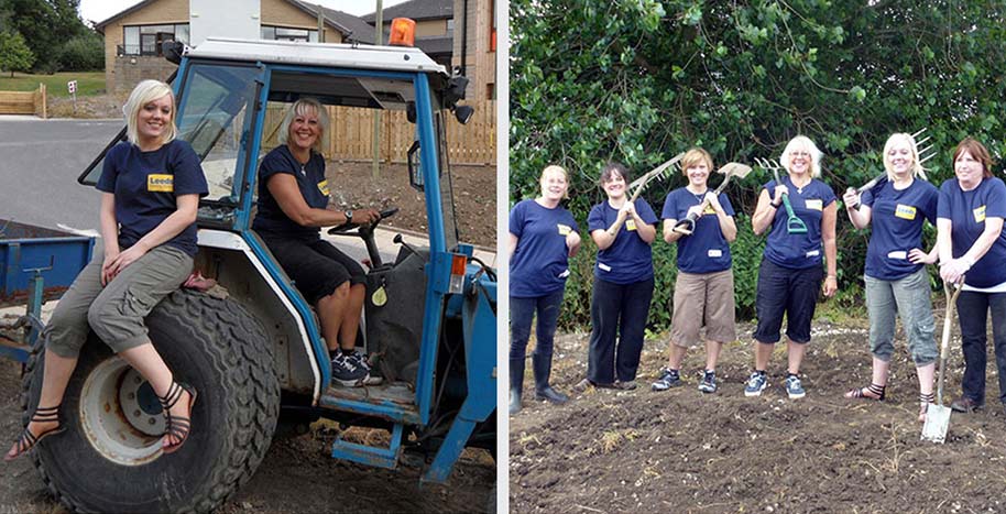 A photo of two women sat in a tractor