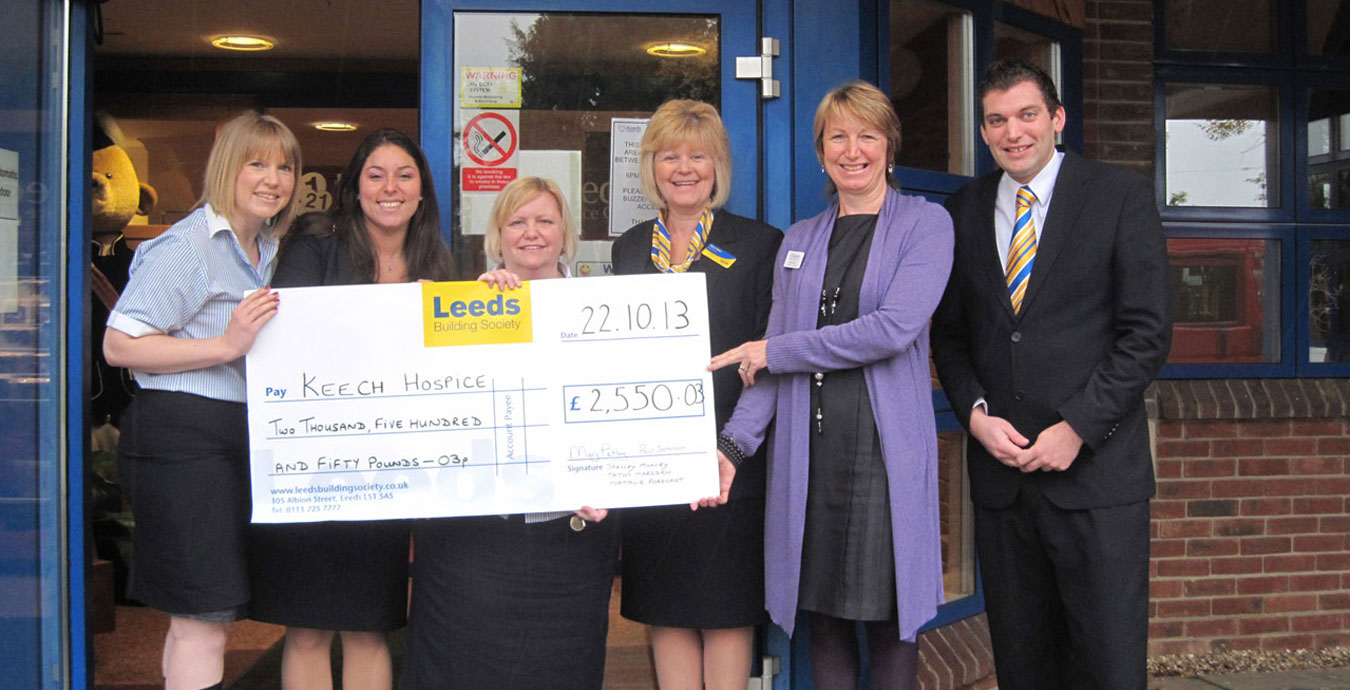 Some members of Leeds Building Society presenting a cheque to Keech Hopsice Care