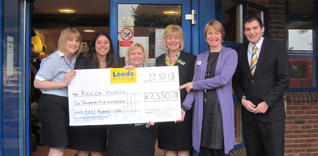 Some members of Leeds Building Society presenting a cheque to Keech Hopsice Care