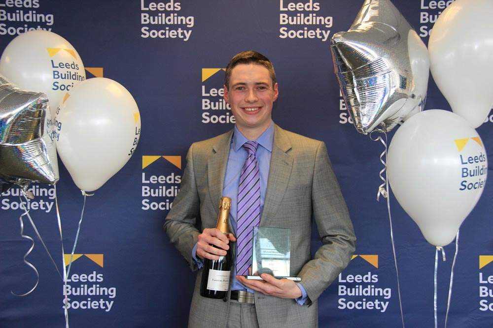 Michael Rhodes is pictured with his ‘Overall Winner’ award and bottle of champagne. 