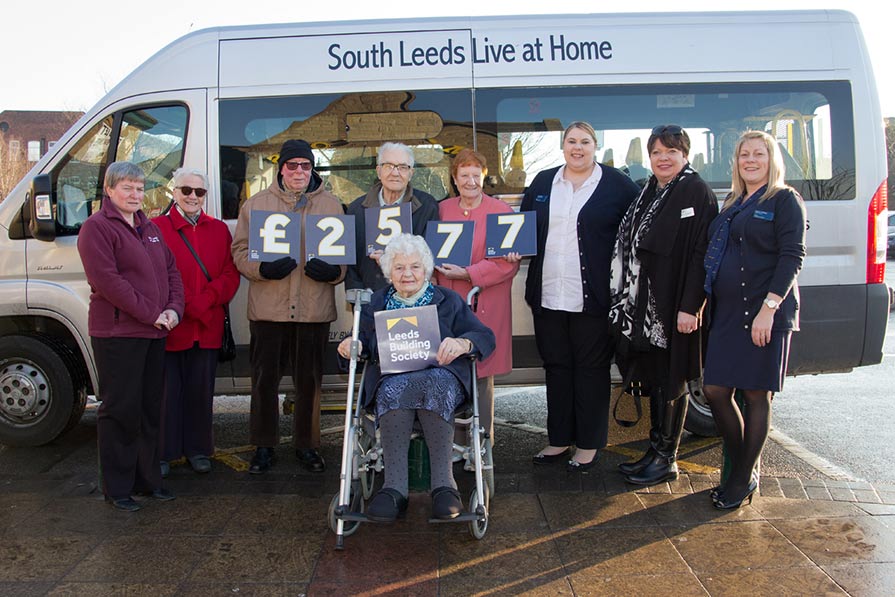 Pictured (L-R) are Nicola Roddy, Dorothy Kavanagh, Jack Kavanagh, Neil King, Mary Allinson (seated), Joan King (all service users), Deborah Bailey (Customer Service Advisor, Morley) Jayne Holland (Manager, South Leeds Live at Home) and Nichola Mullaney (Branch Manager, Morley).