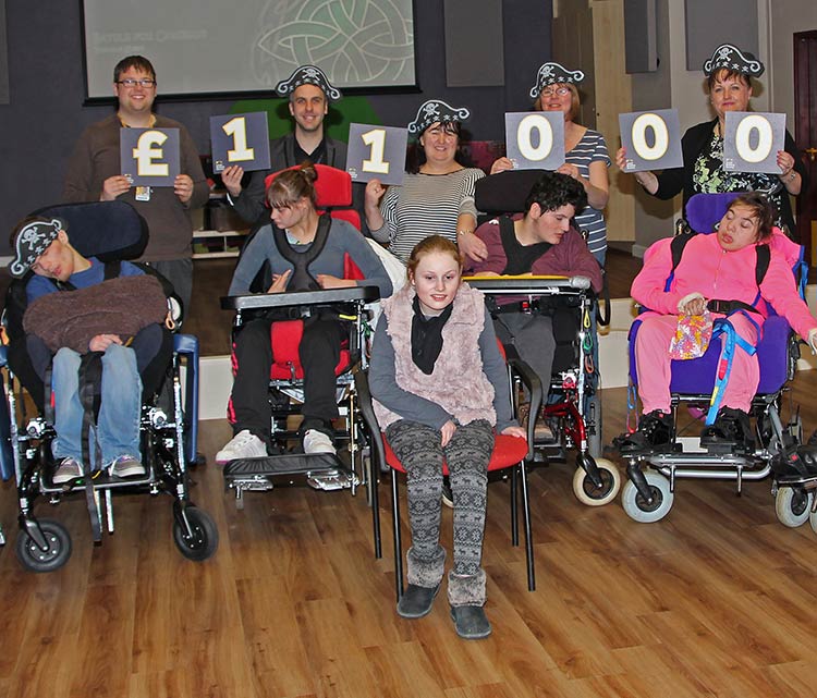 Tony Raine and Jeanette Cartwright from Leeds Building Society are pictured (back row, 2nd from left and far right) alongside Hollybank staff and students.