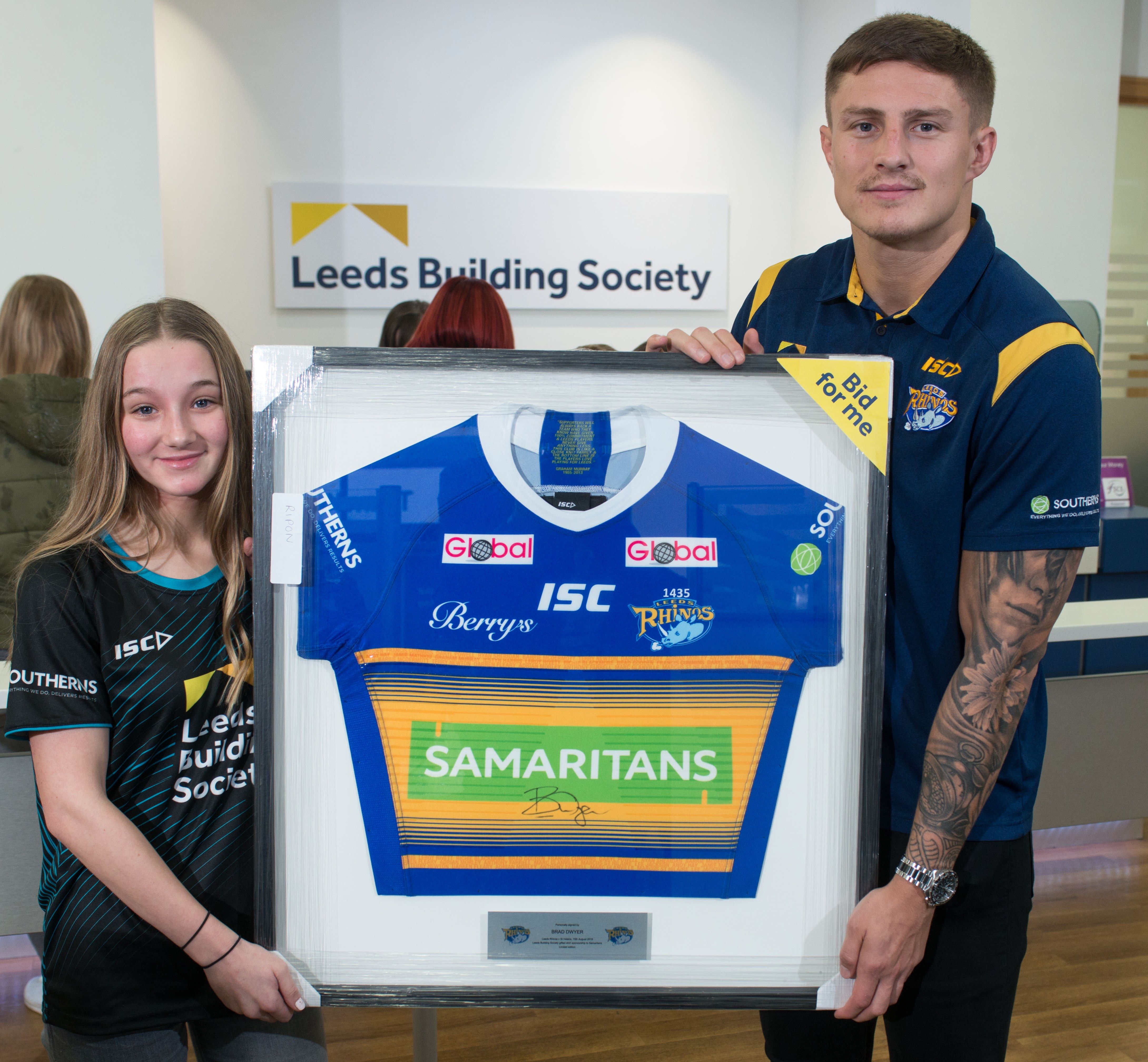 Liam Sutcliffe present the limited edition Samaritans shirt to Emily Blyfield