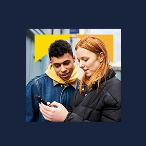 Two people looking at a mobile phone